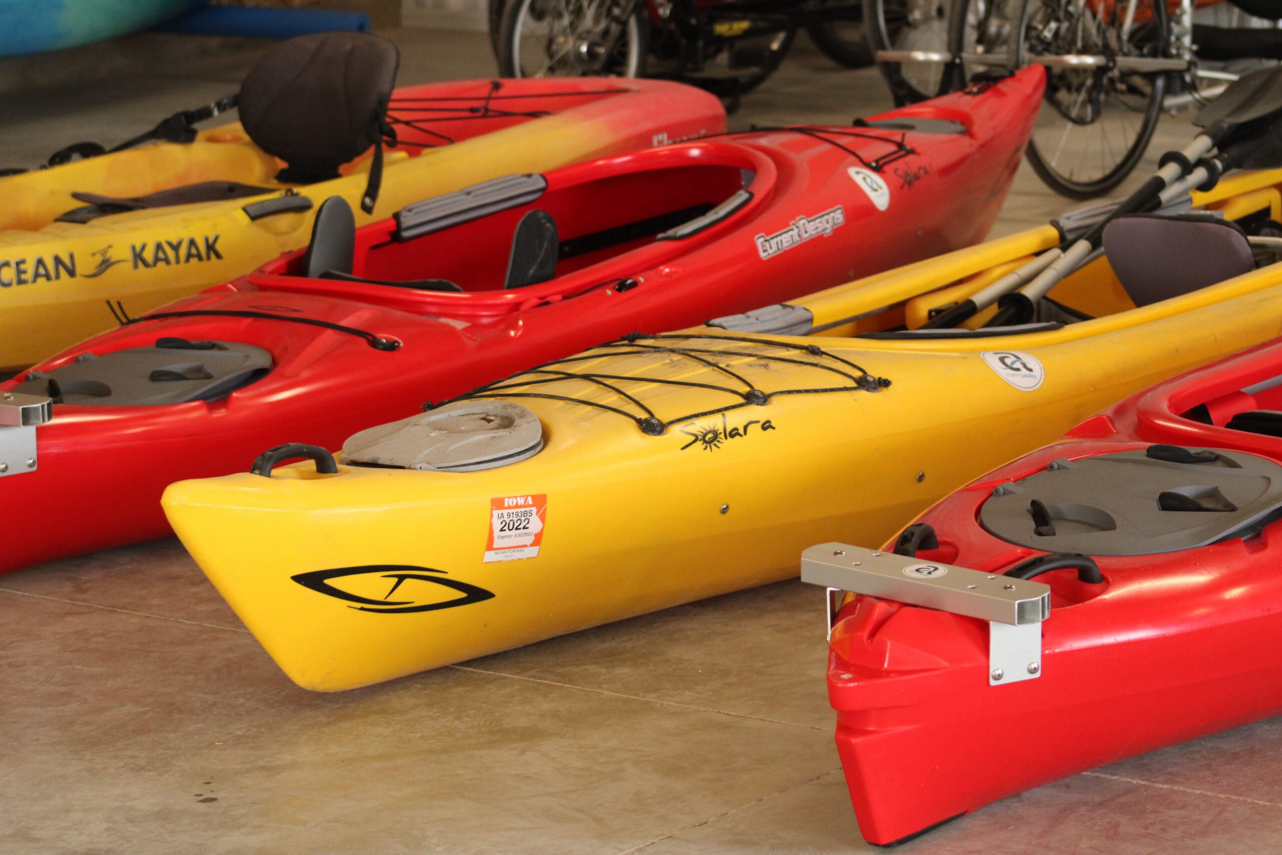 Orange and yellow kayaks lined up.